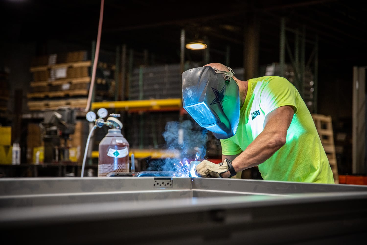 Welder making custom door