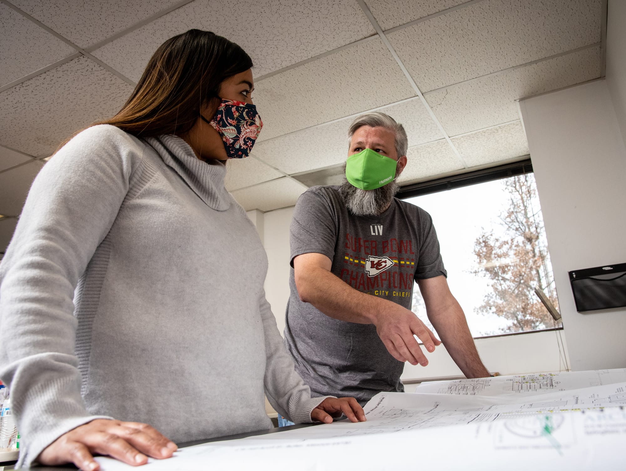 project manager and client looking over plans